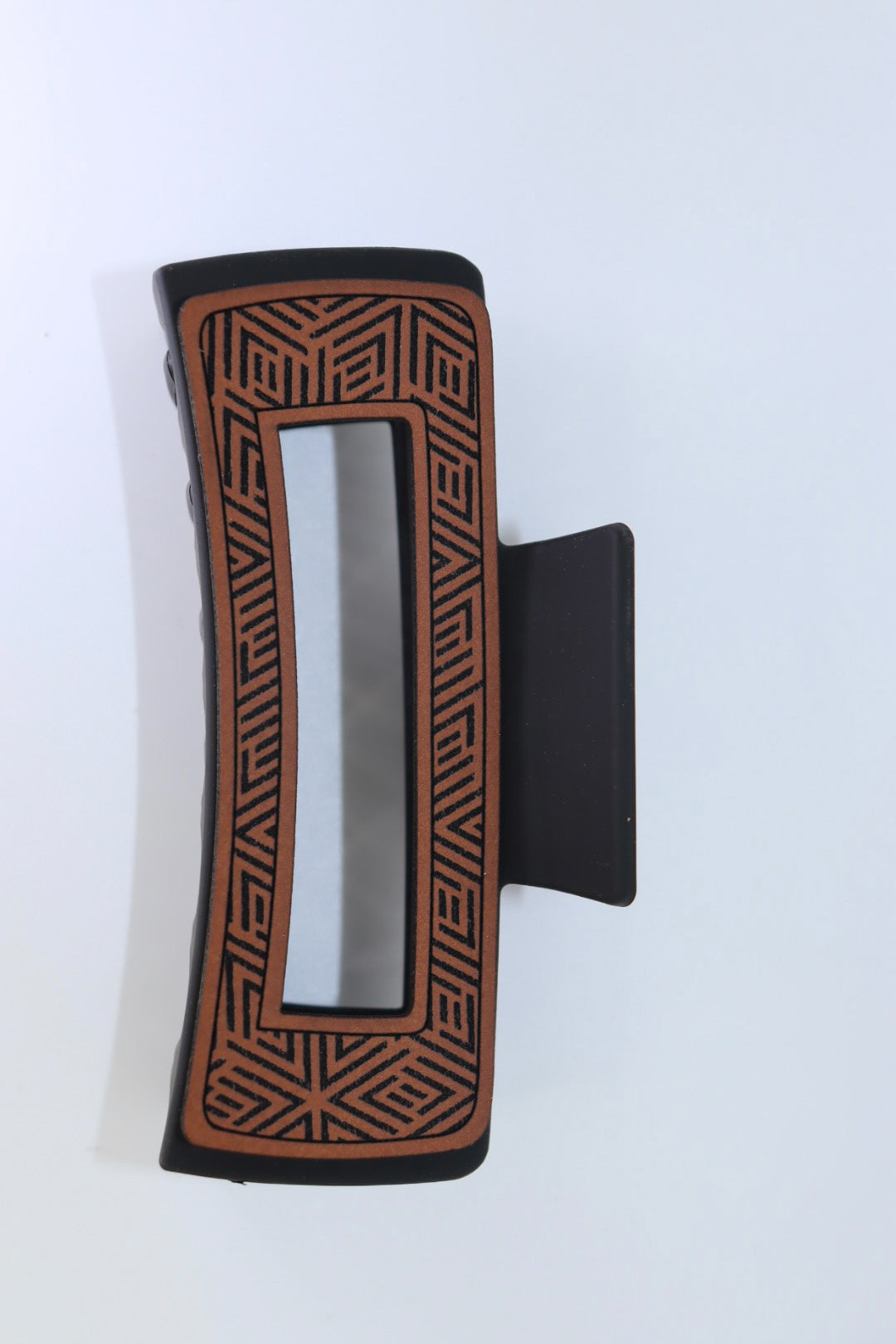 Open geometric print hair claw clip with leather detailing