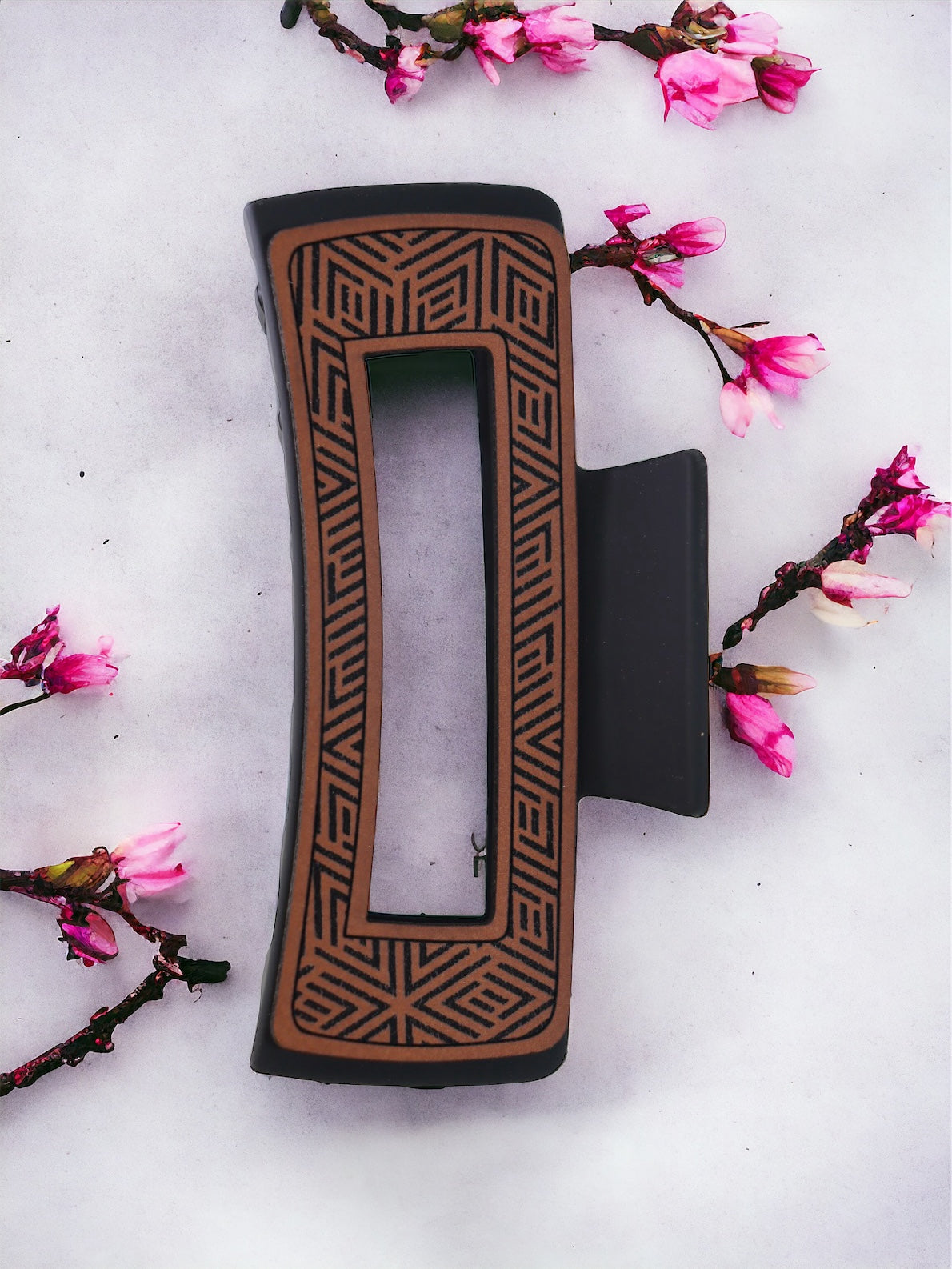 Open geometric print hair claw clip with leather detailing
