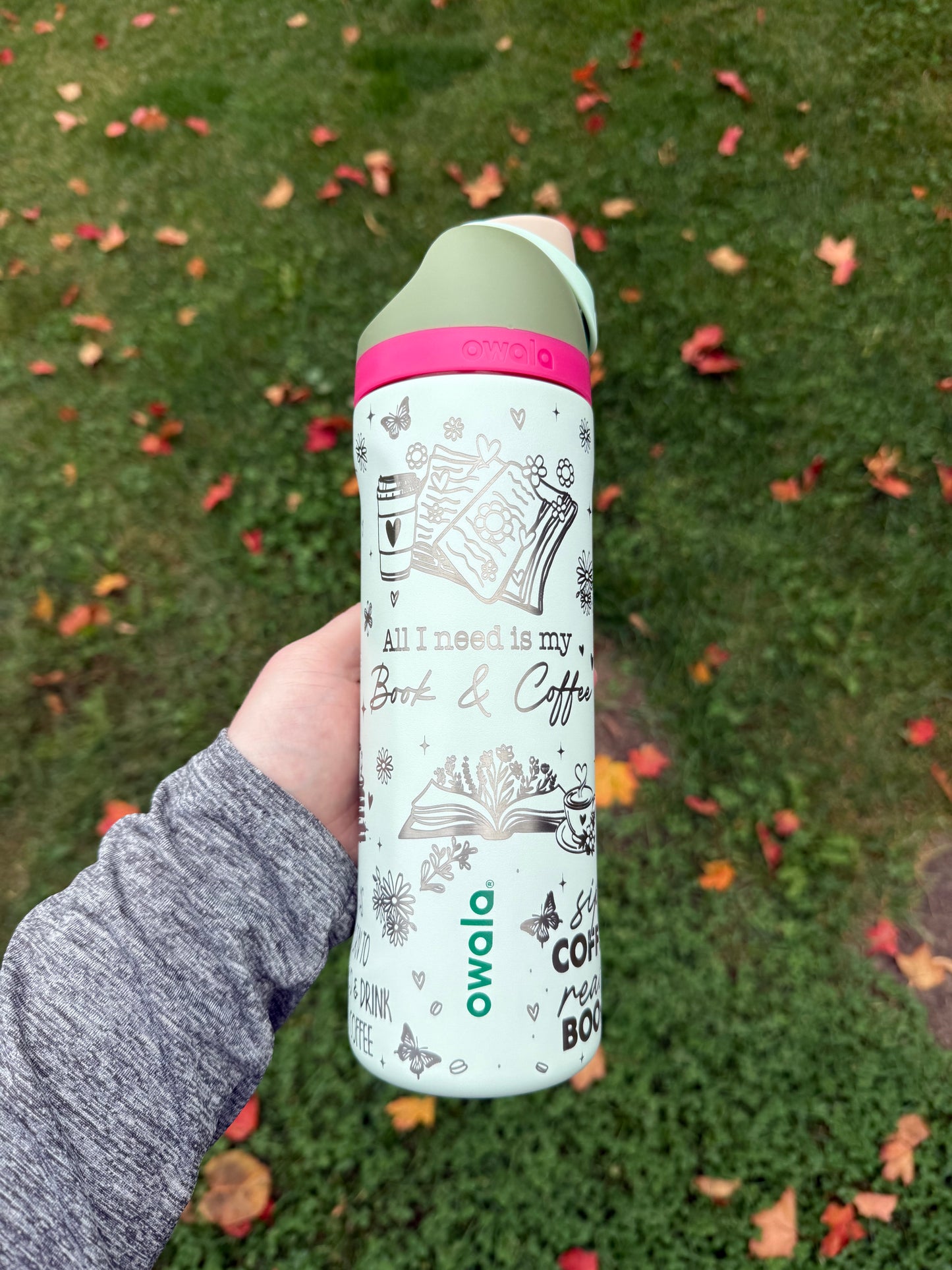 Person holding a cylindrical product with a label against a grassy background