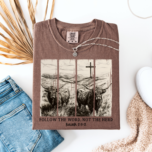Brown Comfort Colors t-shirt featuring western highland cattle artwork with a cross and the phrase ‘Follow the Word Not the Herd’ Isaiah 8:11-13