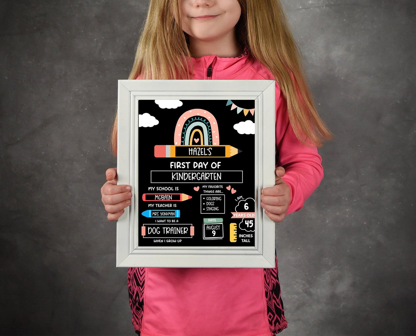 Young girl holding editable first day of kindergarten sign for school photo prop