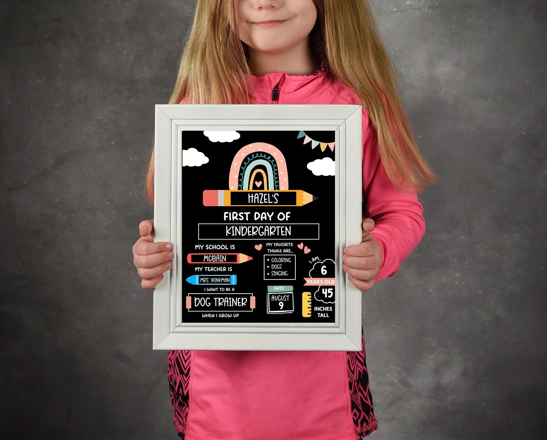 Young girl holding editable first day of kindergarten sign for school photo prop