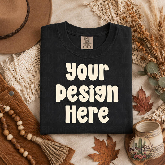 Folded Comfort Colors black t shirt mockup styled in a cozy boho fall flat lay with autumn leaves, neutral textures, dried florals, and warm earthy decor.