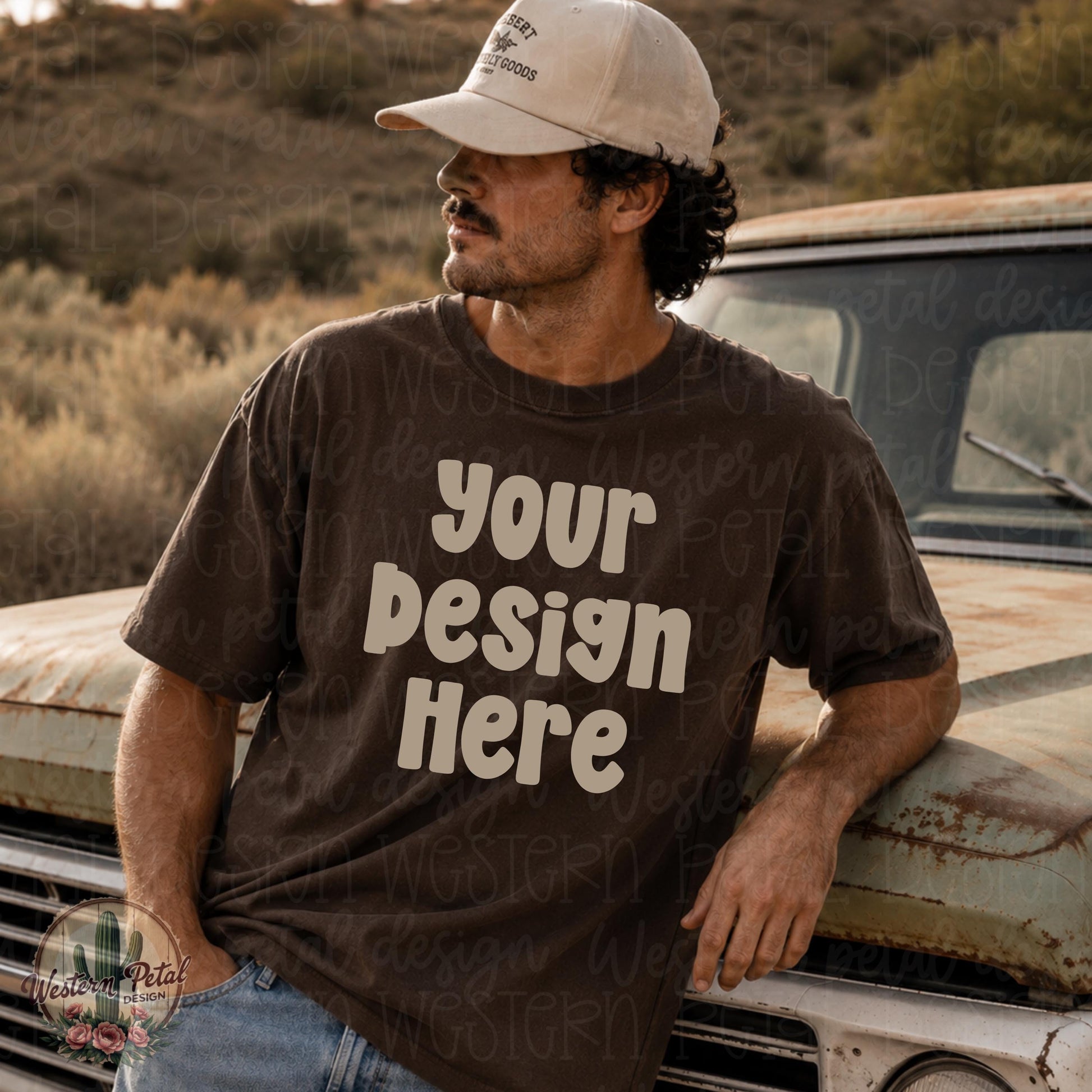 Rugged western-style male mockup wearing a blank Comfort Colors 1717 espresso brown t-shirt while leaning against a vintage truck in a desert landscape. Neutral earthy tones with masculine outdoors aesthetic perfect for western or boutique apparel mockups.