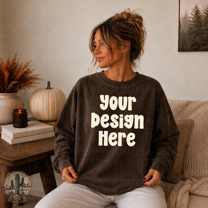 Trendy brunette woman in espresso Comfort Colors 1566 crewneck sweatshirt sitting in cozy neutral fall themed room.