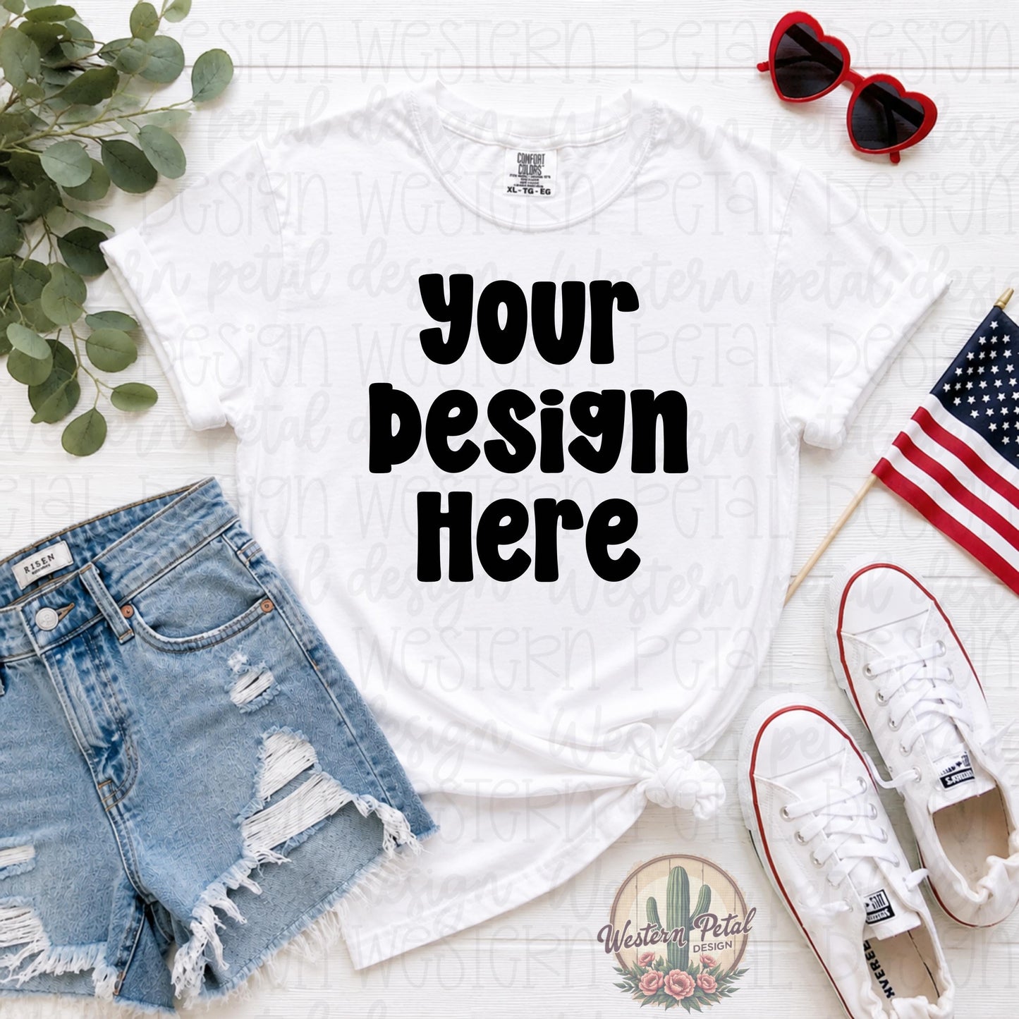 Comfort Colors white t-shirt mockup with distressed denim shorts, white sneakers, patriotic American flag, and heart sunglasses styled in a flat lay for Fourth of July shirt designs.