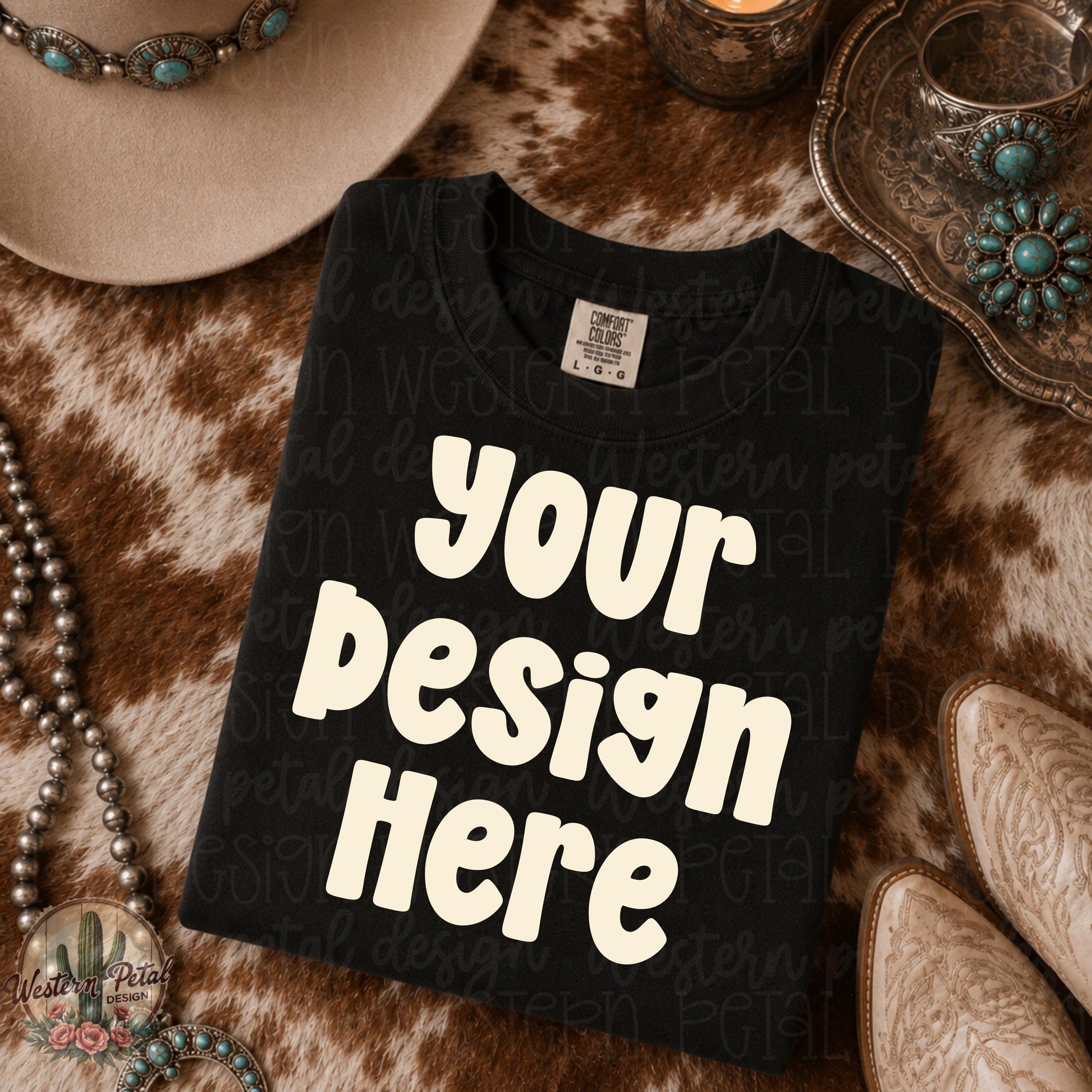 Black Comfort Colors folded shirt mockup styled on western cowhide rug with turquoise jewelry cowboy hat and western glam decor