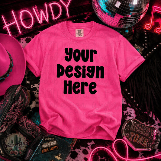 Comfort Colors Neon Pink t-shirt mockup surrounded by western boots, pink cowboy hat, disco ball, neon honky tonk signs, and fringe purse.